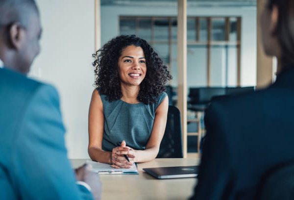 Shot of group of business persons in business meeting. Three entrepreneurs on meeting in board room. Corporate business team on meeting in modern office. Female manager discussing new project with her colleagues. Company owner on a meeting with two of her employees in her office.